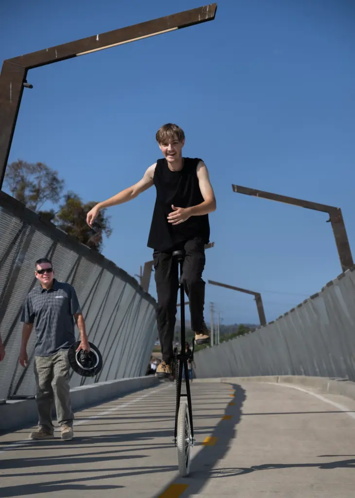Darren Junge rides his 5-foot-tall unicycle across the Jeffrey Open...