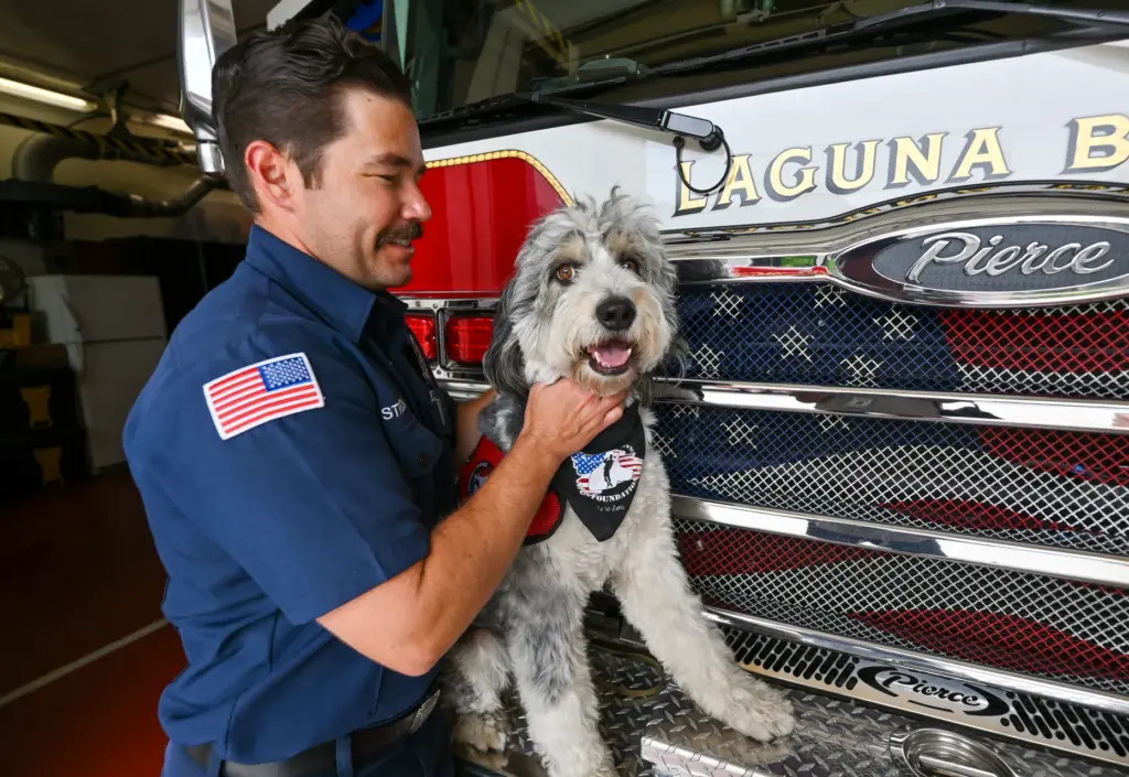 Laguna Beach Firefighter/Paramedic Logan Strook with Oro, a 2-year-old Aussiedoodle...