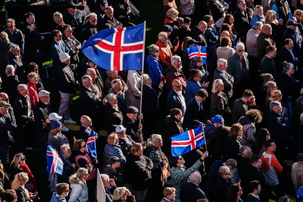People with Icelandic flags attend an “Afram Island”, “Forward, Iceland”,...