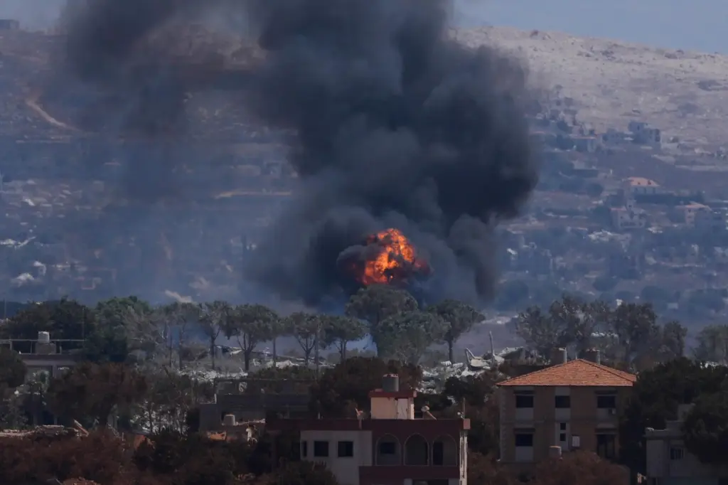 Smoke and flames rise as Israeli forces demolish homes in...