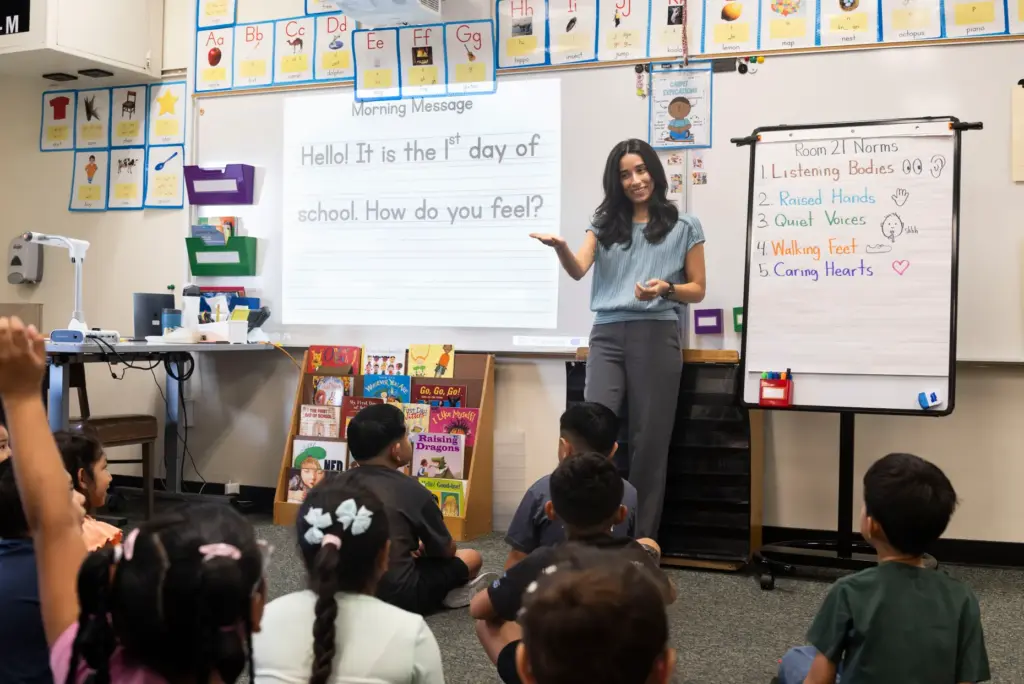 First grade teacher Margarita Recinos talks to her class during...