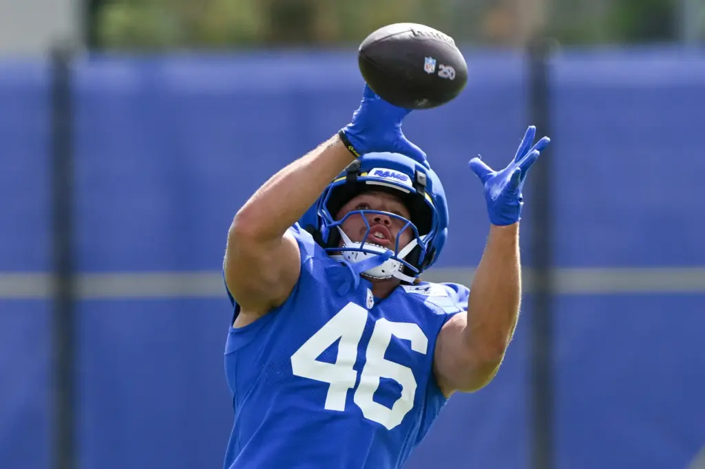 Rams tight end Rohan Jones reaches to catch a pass...
