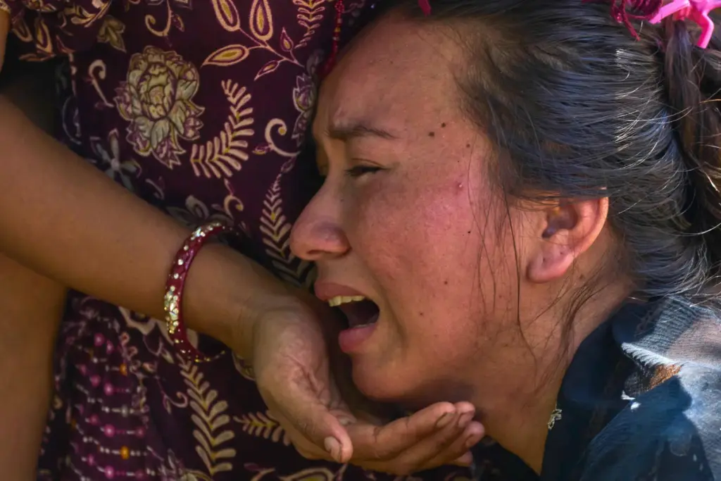 A girl cries as she waits for news of relatives missing after flash floods in Nepal.