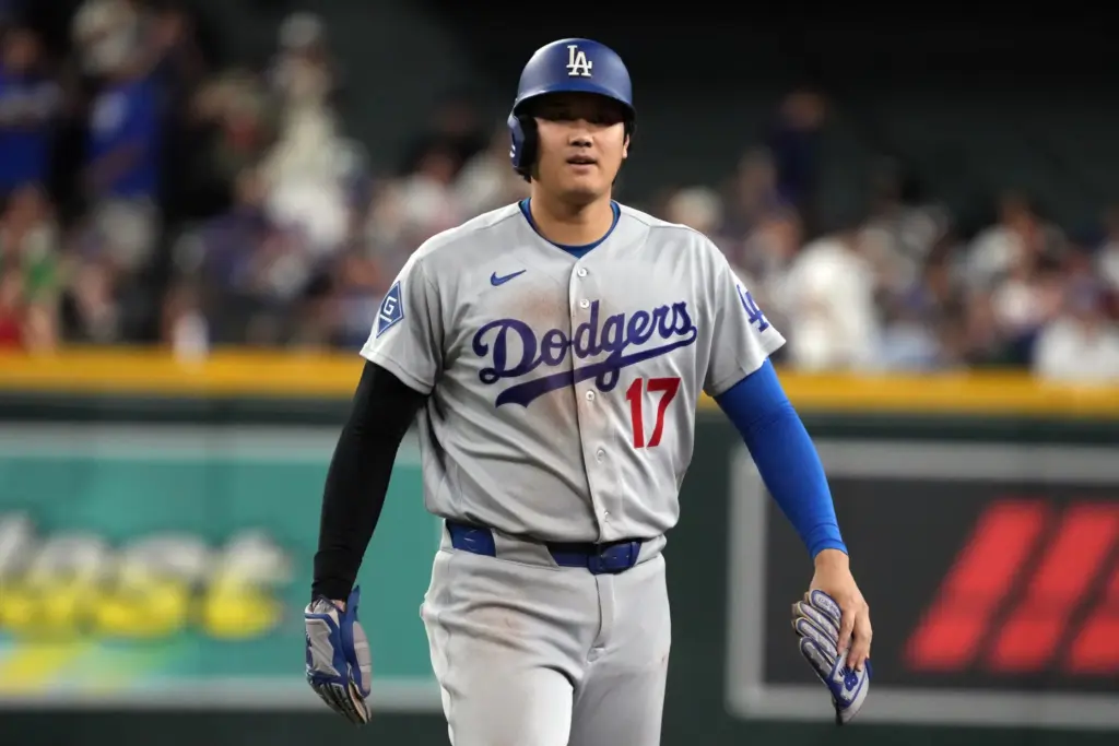 Dodgers star Shohei Ohtani looks to his dugout after getting...