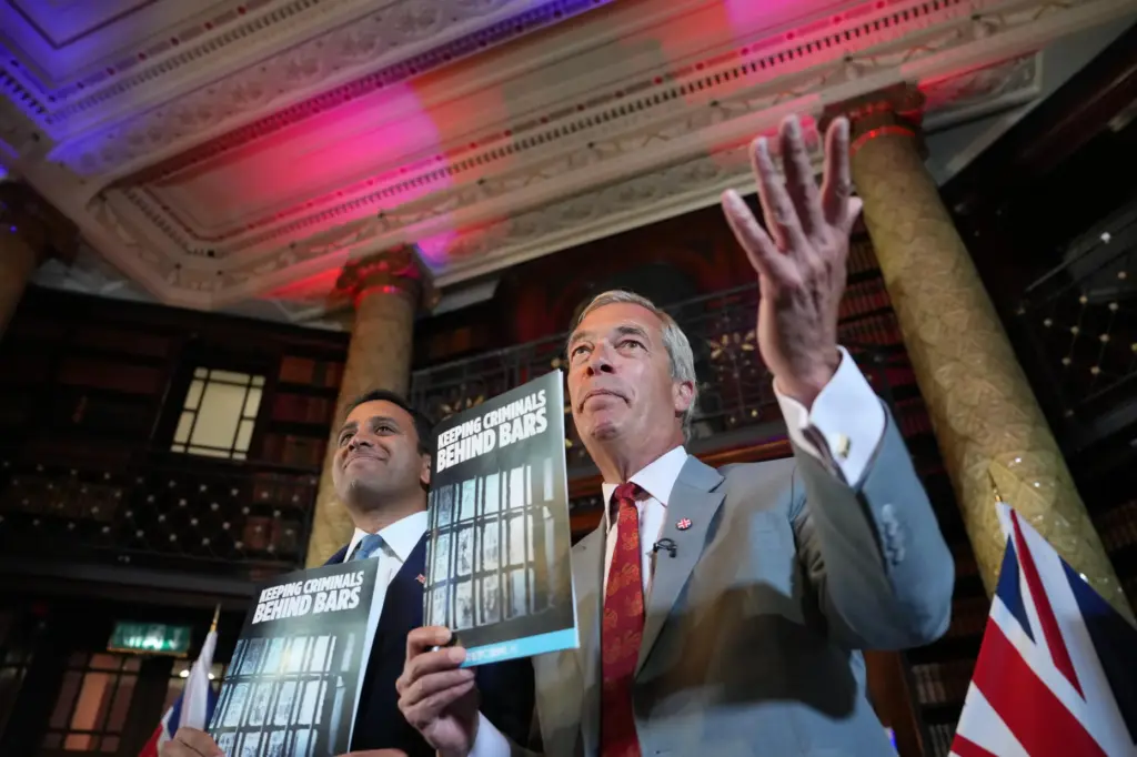 Nigel Farage, Leader of Britain’s Reform UK party, right, and...