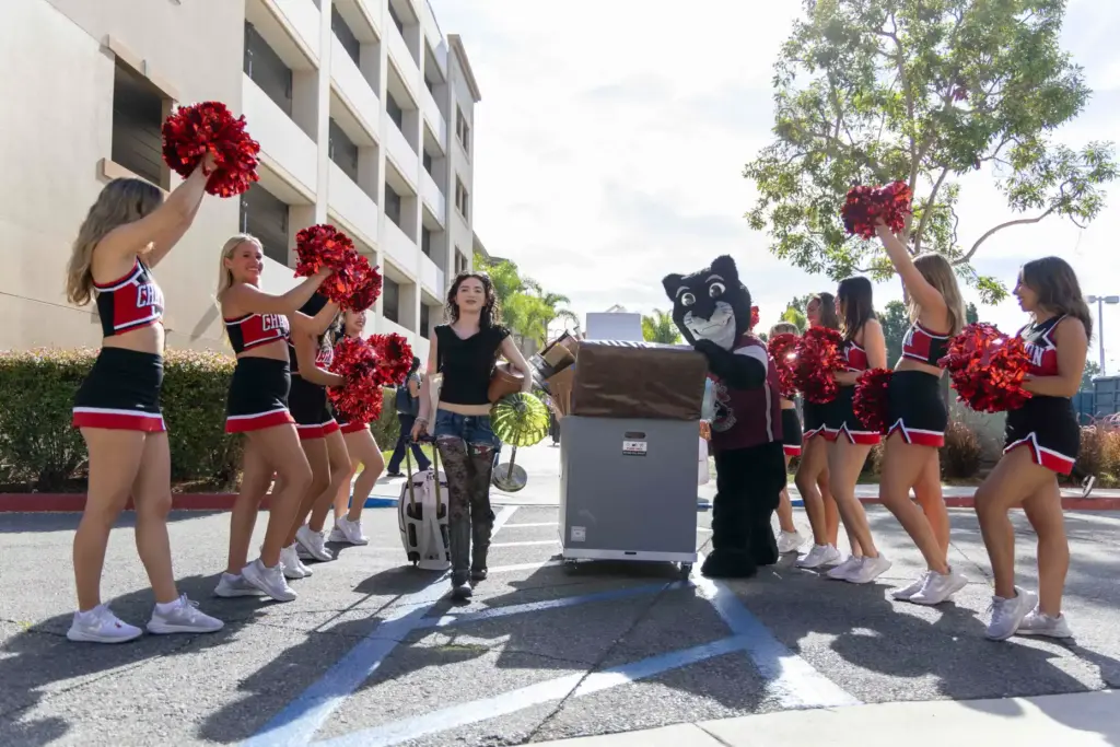 Pete the Panther helps first-year student Izzie Coffey push a...