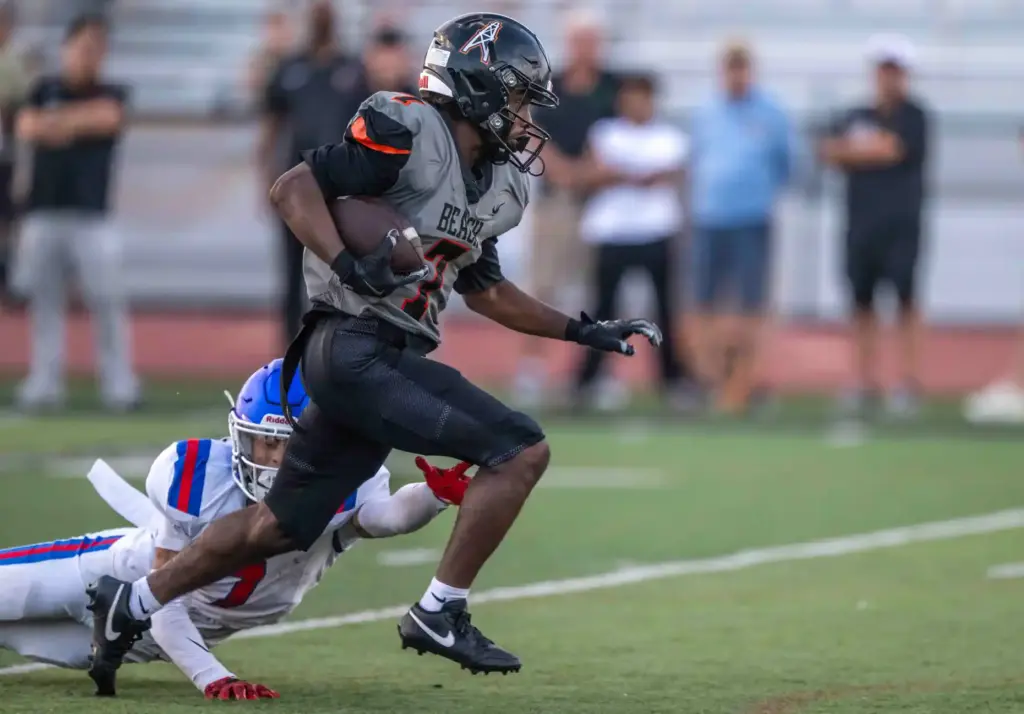 Huntington Beach wide receiver Kye Crump (7) carries the ball...