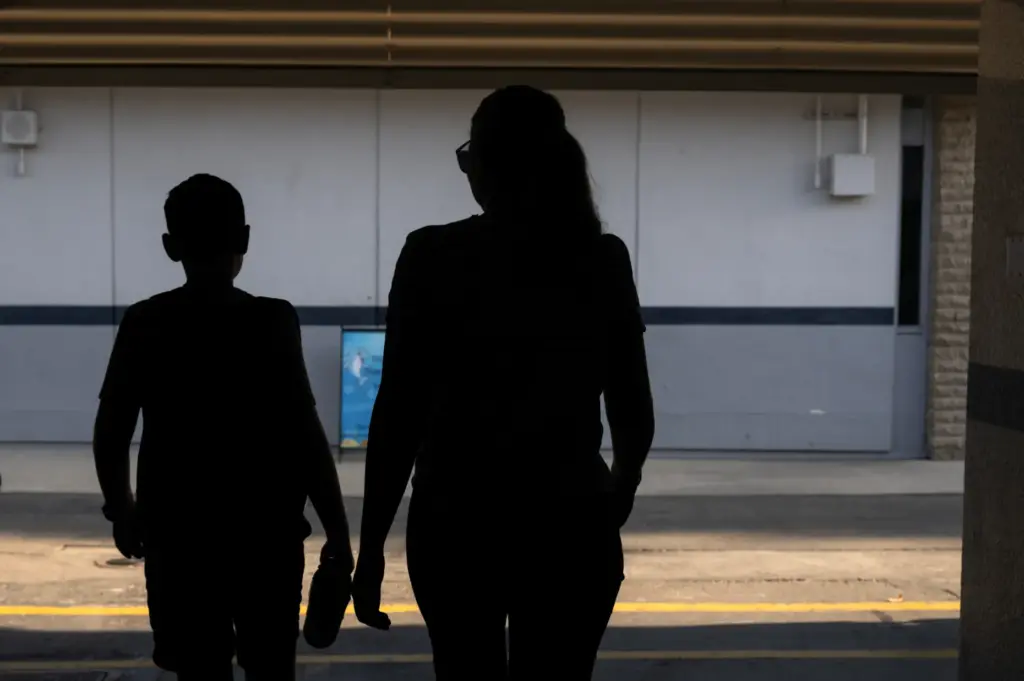 Children arrive with their parents at Pacific Drive Elementary School...