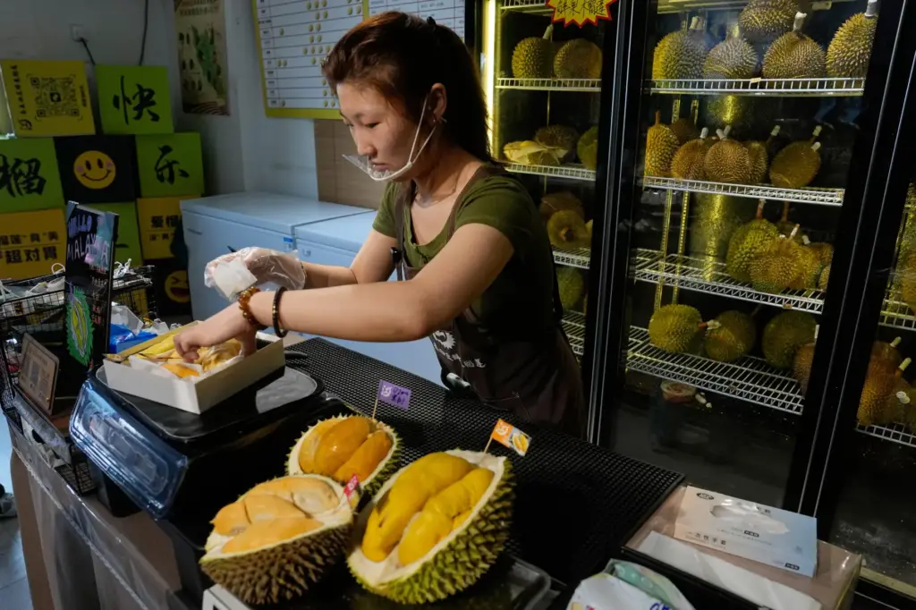 Worker Hou Yuxin packs durian fruit imported from Malaysia.