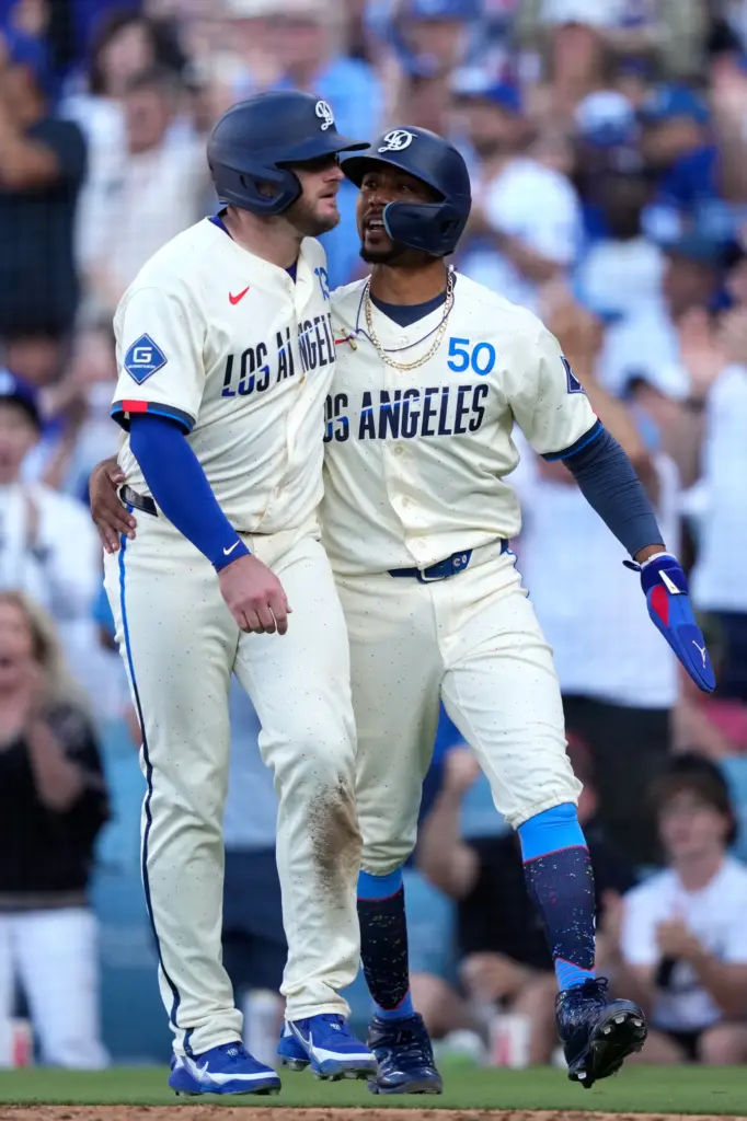 Dodgers’ Max Muncy, left, and Mookie Betts celebrate after scoring...