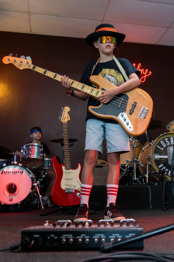 Blake Severson, 10, practices his bass set before his performance...