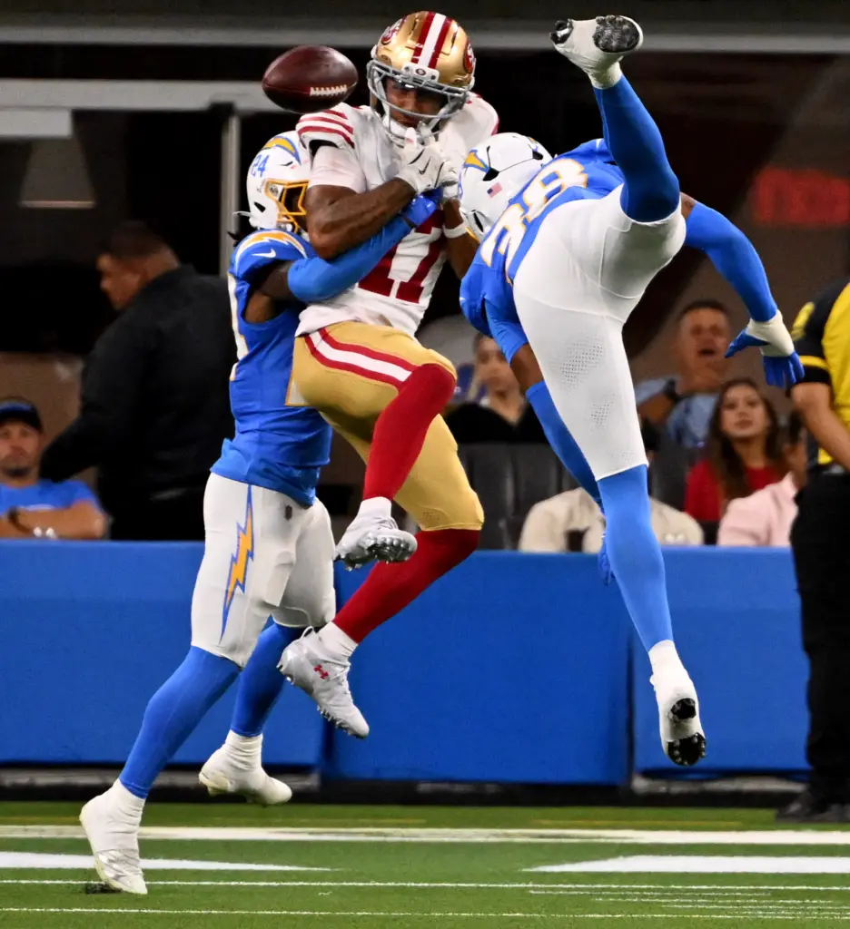 San Francisco 49ers wide receiver Jordan Watkins, middle, drops a...