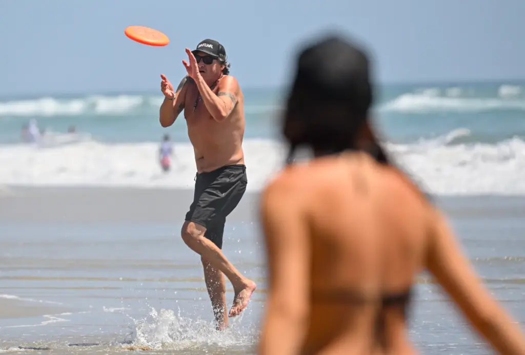 Maurice Sandoval plays frisbee with his girlfriend, Veronica Rodriguez, on...