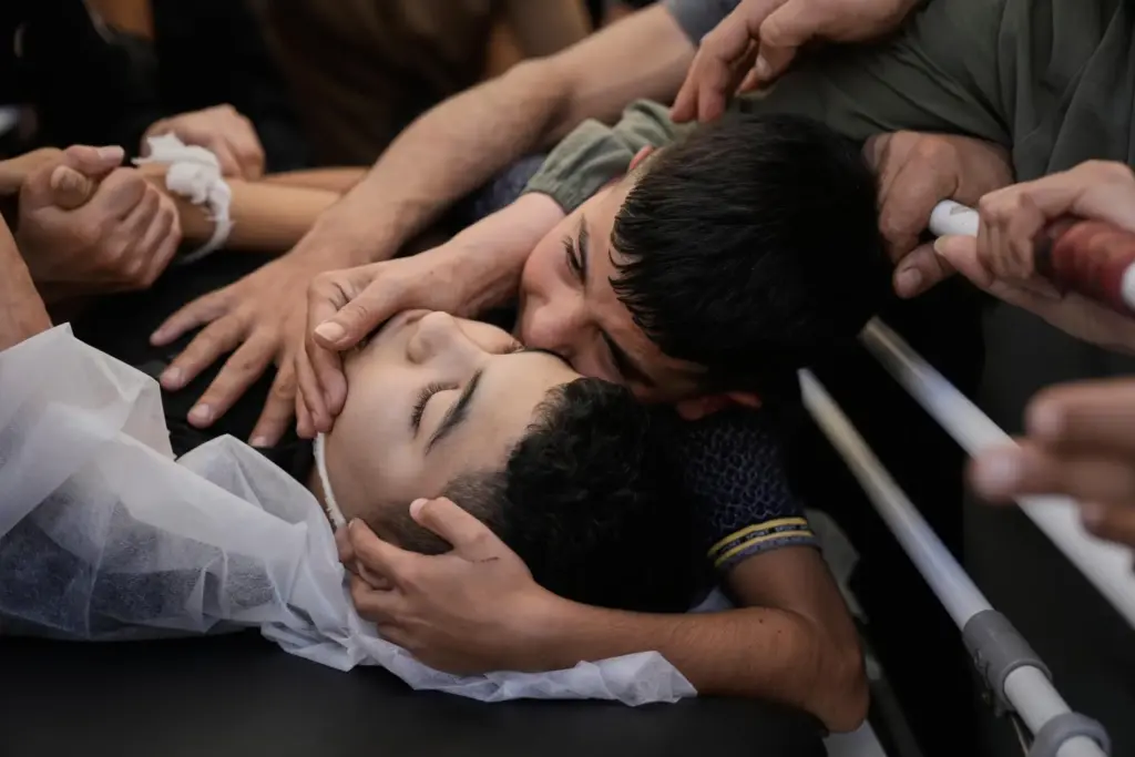 Mohammed Ajouri mourn over the body of his brother Islam...