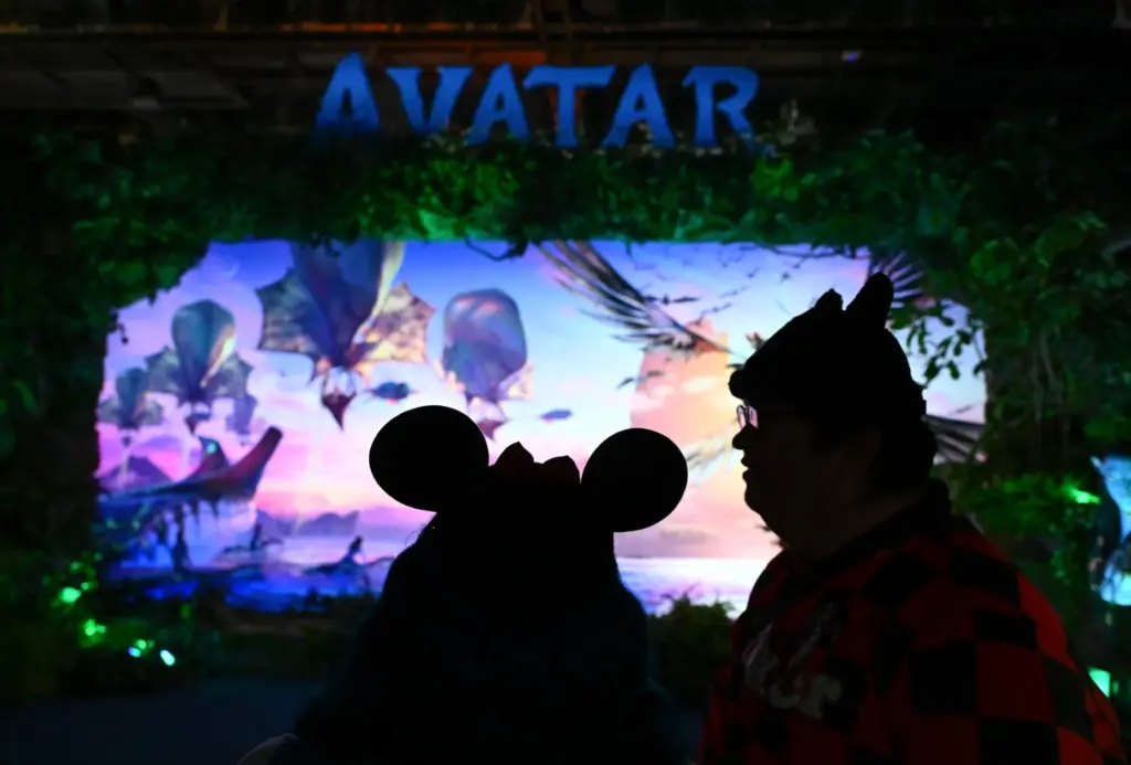 People wait in line for the Avatar booth during the...