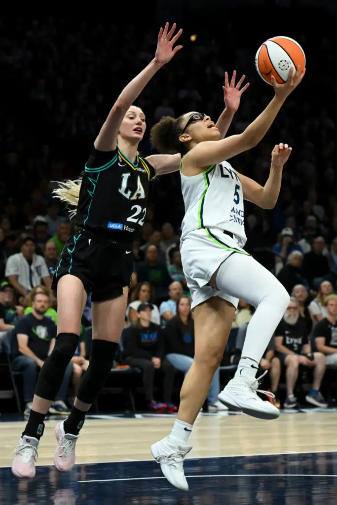 Minnesota Lynx guard Olivia Miles, right, attempts a layup as...