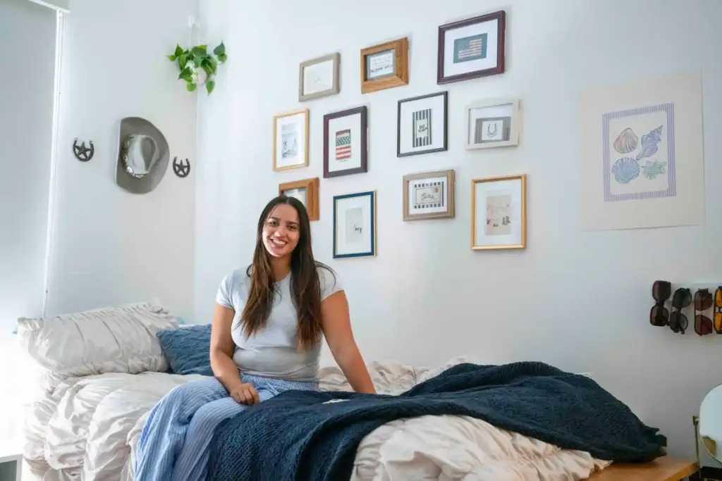 Sophomore Natalie Buffolino poses for a portrait on her bed...
