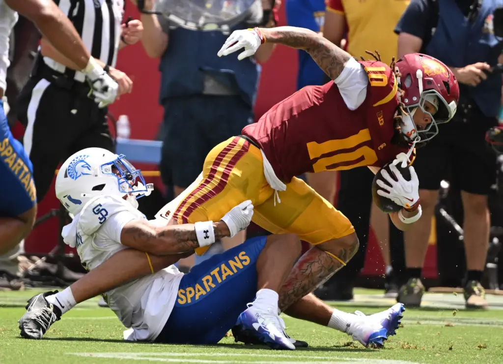 Wide receiver Corey Simms (10) of the USC Trojans catches...