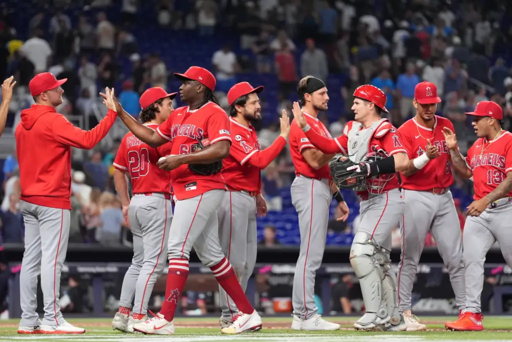 Angels players, including relief pitcher Jose Fermin, third from left,...