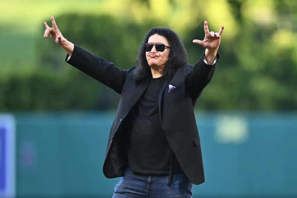 Gene Simmons from the band KISS gestures before a baseball...