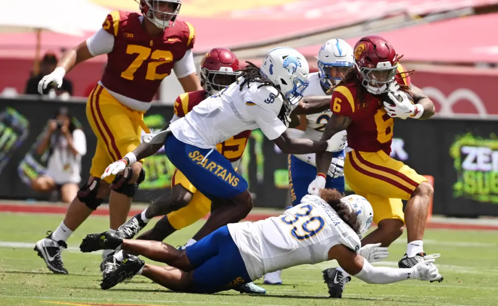 Running back Deshonne Redeaux (6) of the USC Trojans runs...