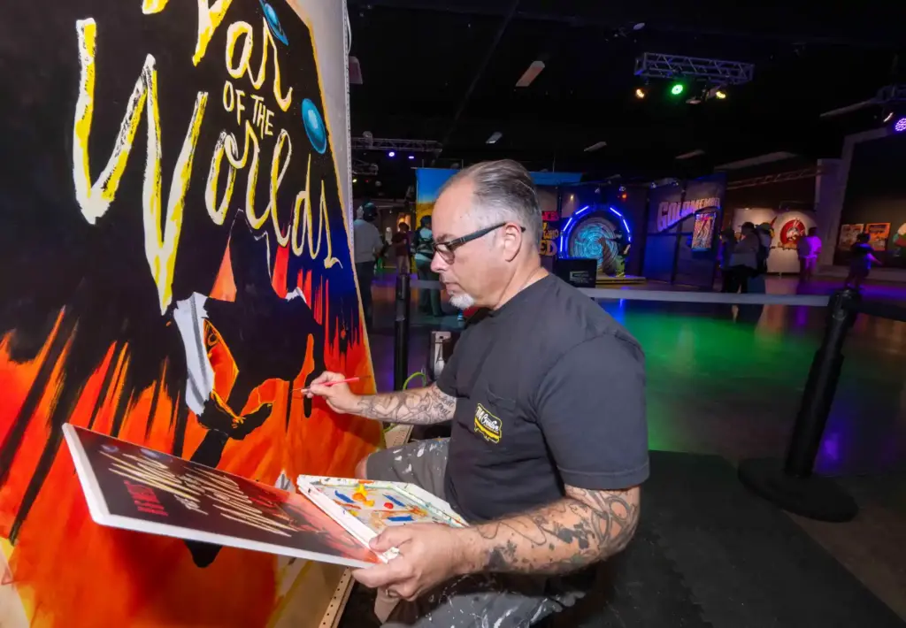 Artist Scotty Roller paints a âWar of the Worldsâ poster...