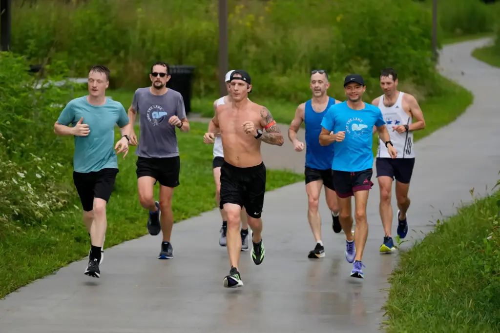 Members of the Raccoon River Running Club train on a trail at Raccoon River Park.