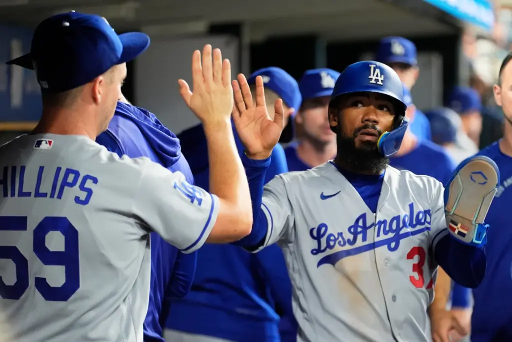 The Dodgers’ Teoscar HernÃ¡ndez celebrates in the dugout after scoring...