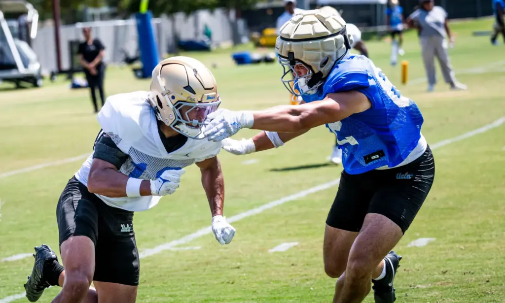 UCLA defensive back Malik Hartford, left, goes through drills during...