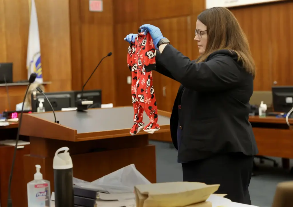 Assistant District Attorney Jennifer Sprague holds up the pajamas of Callan Clancy.