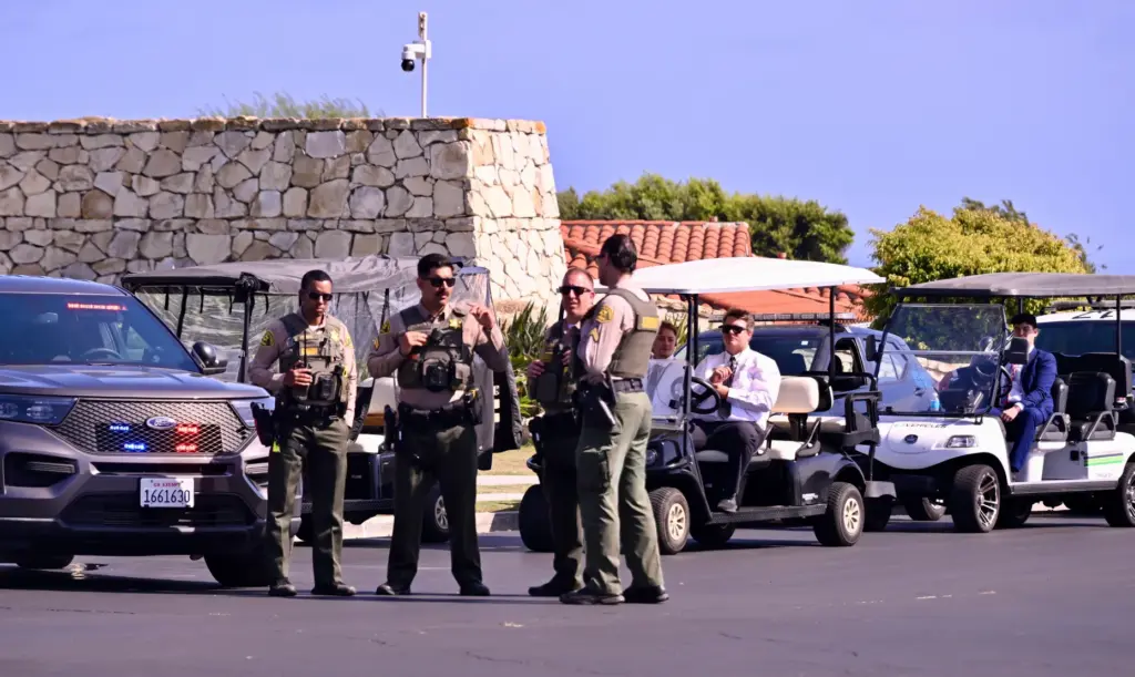 Los Angeles County Sheriffs and Secret Service stand guard in...
