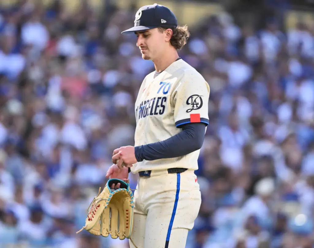Starting pitcher Justin Wrobleski of the Dodgers reacts after hitting...