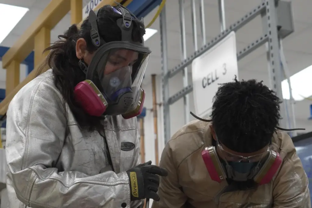 Phoenix Tailings' workers clad in personal protection equipment as they harvest an alloy