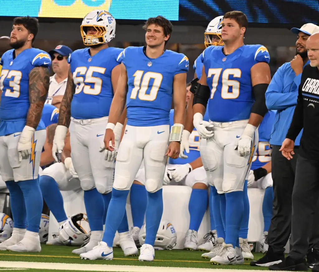 Chargers quarterback Justin Herbert (10) looks on from the sidelines...