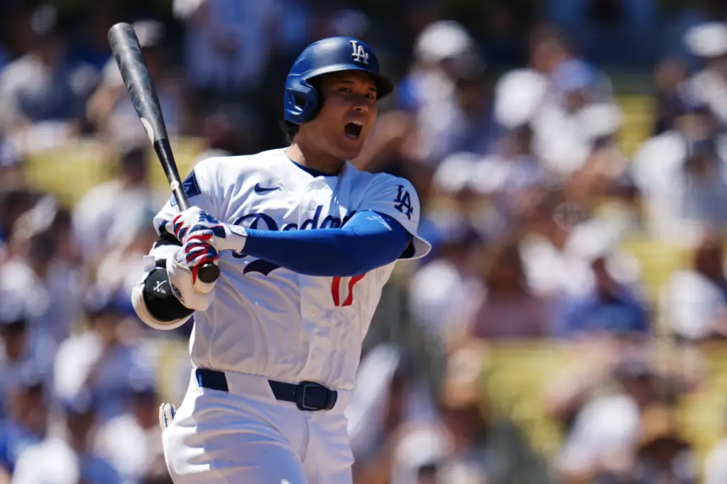 Dodgers’ Shohei Ohtani reacts while batting during the third inning...