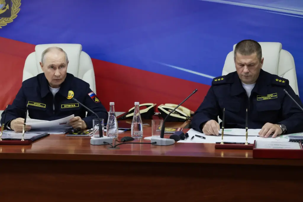 Russian President Vladimir Putin and Russian Pacific Fleet Commander-in-Chief Admiral Viktor Liina attend a meeting.