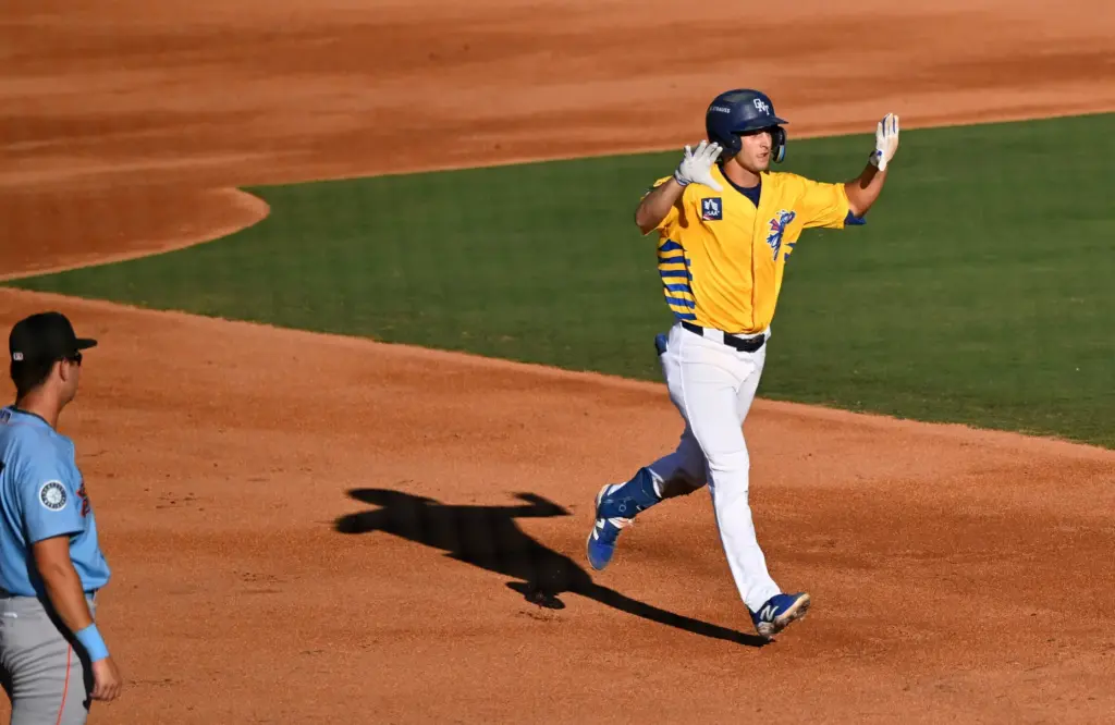 Kellon Lindsey runs through the bases after hitting a home...