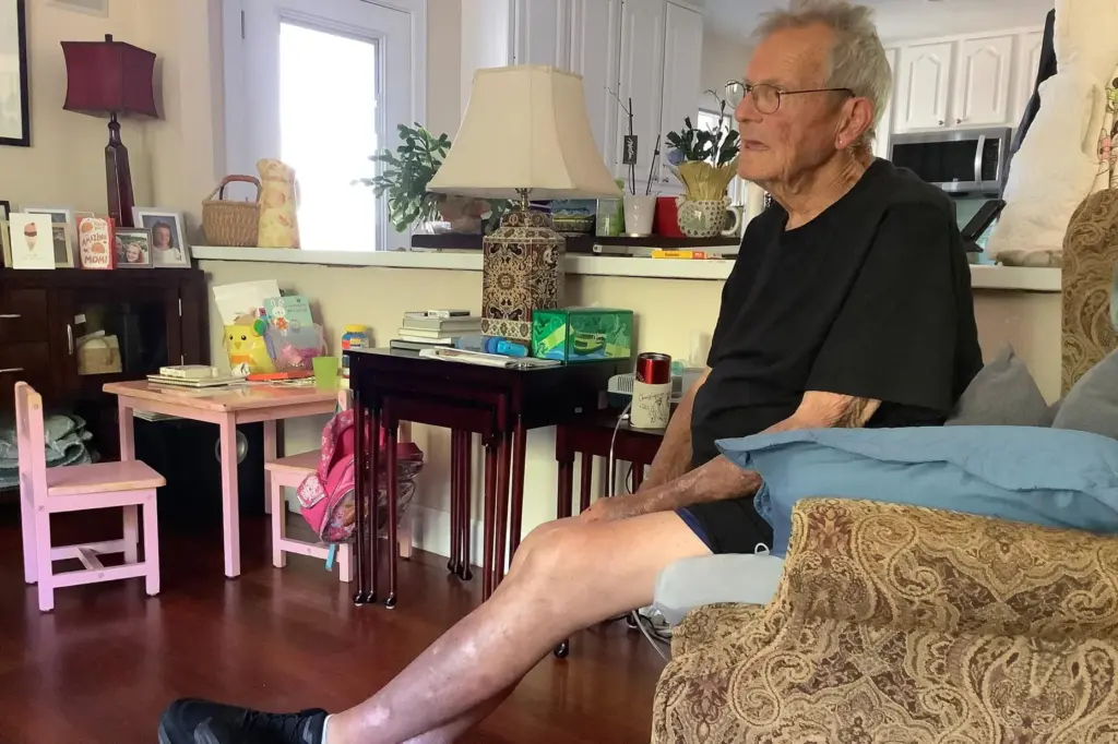 Hospice patient Mark Vantrease sits in the living room of...
