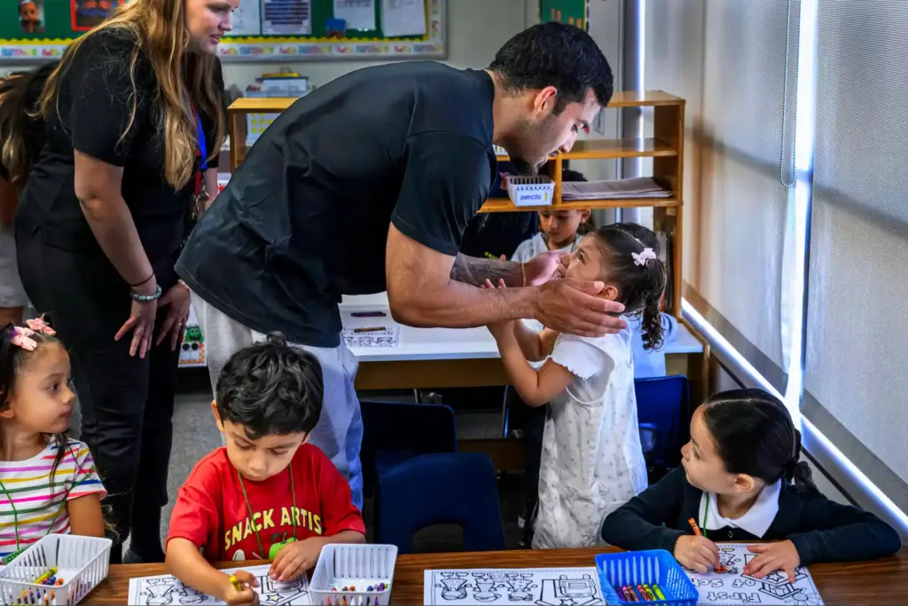 Miguel Gonzalez says goodbye to his teary-eyed daughter Aminah, 4,...