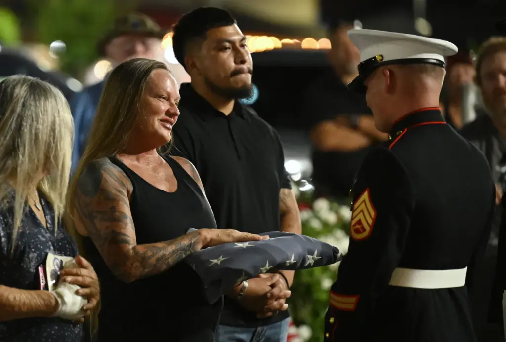 Marine Lance Cpl. Kareem Nikouiâs mother, Shana Chappell receives a...
