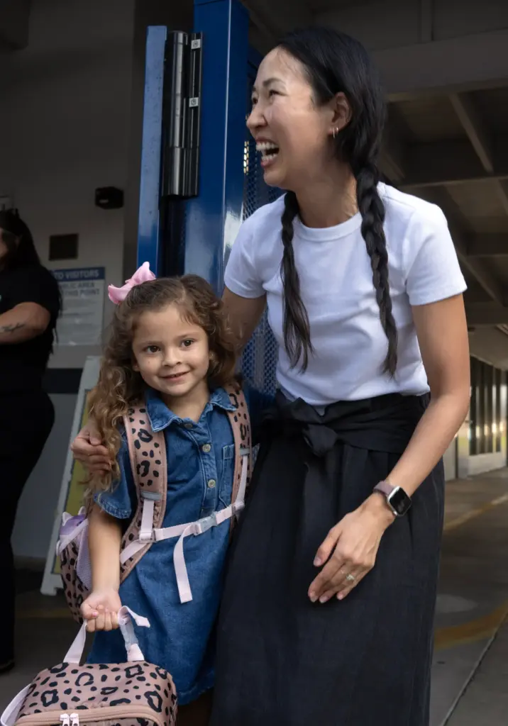 Pacific Drive Elementary teacher Amy Song greets students during the...