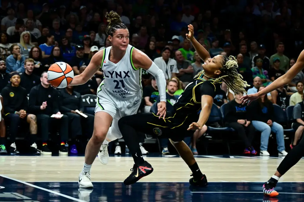 Minnesota Lynx guard Kayla McBride, left, is called for an...