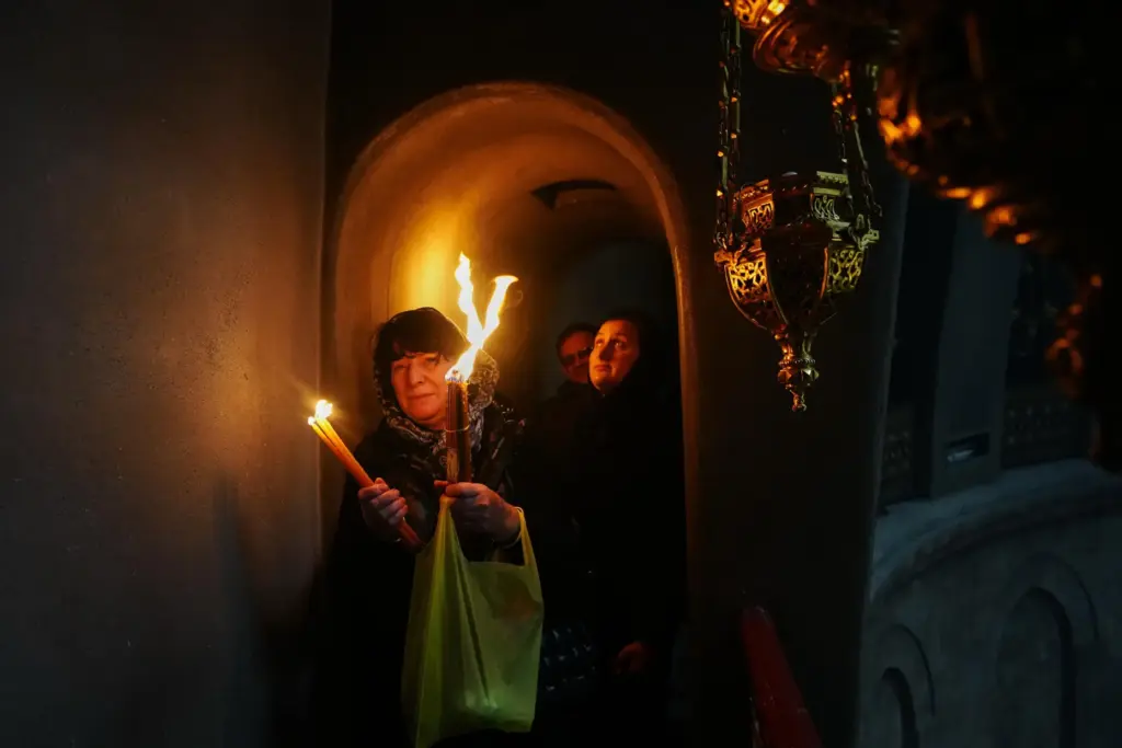 Christian Orthodox pilgrims hold up candles during the Holy Fire ceremony.