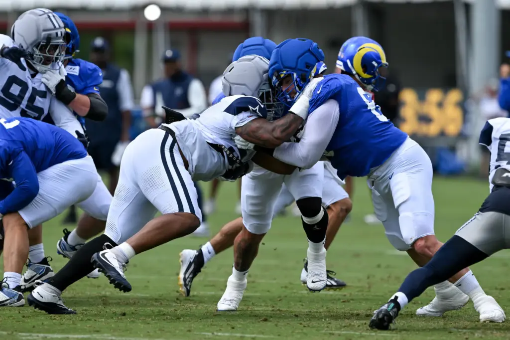 Rams offensive lineman Bill Murray, right, blocks against Dallas Cowboys...