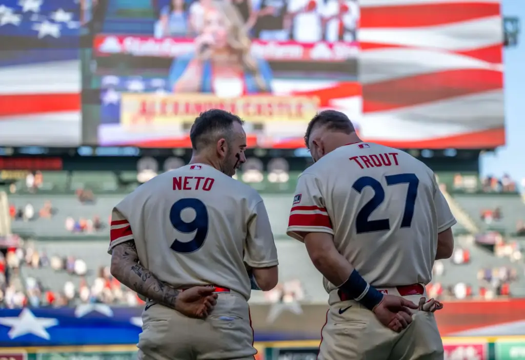 Angels stars Zach Neto (9), left, and Mike Trout (27)...