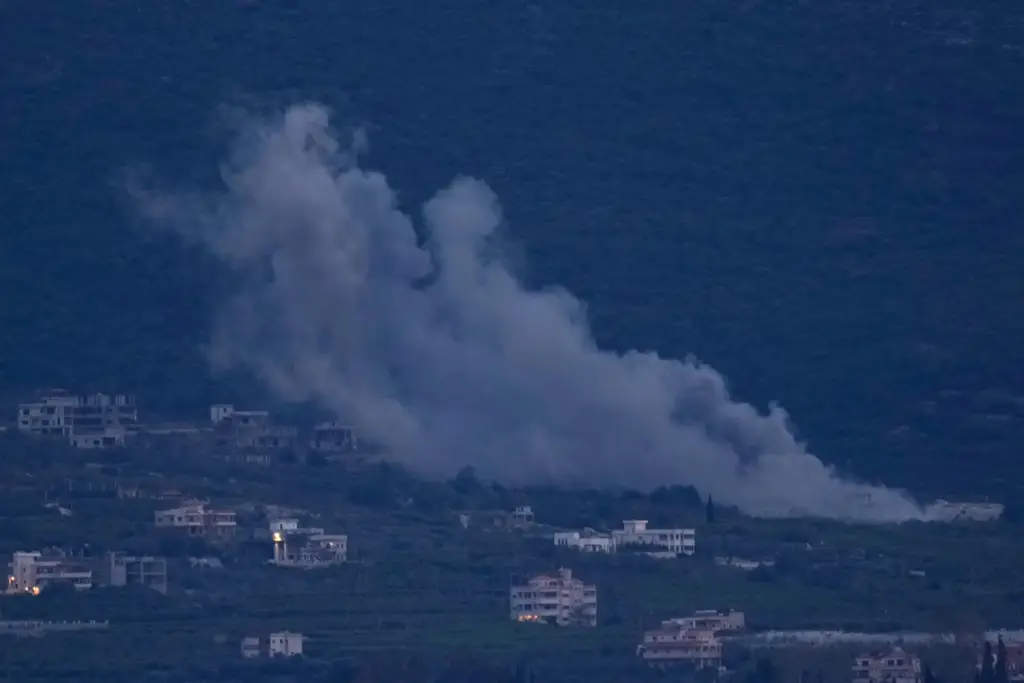 FILE — Smoke rises from an Israeli airstrike that hit...