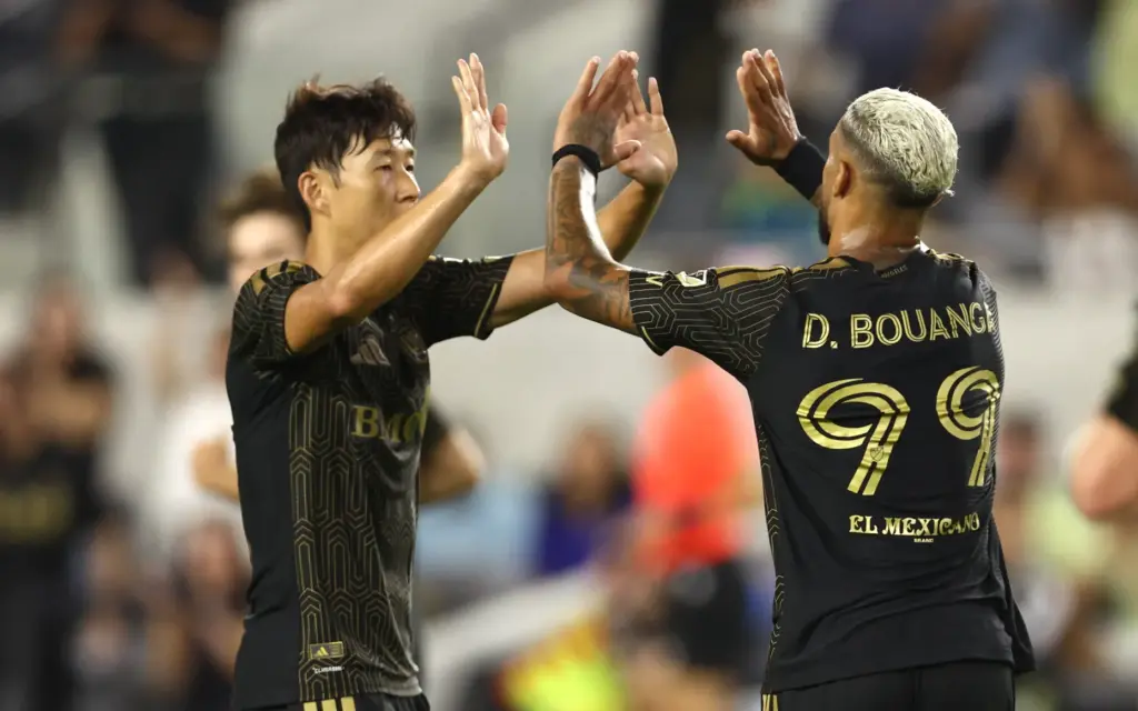 LAFC forward Denis Bouanga (99) high-fives forward Son Heung-Min after...