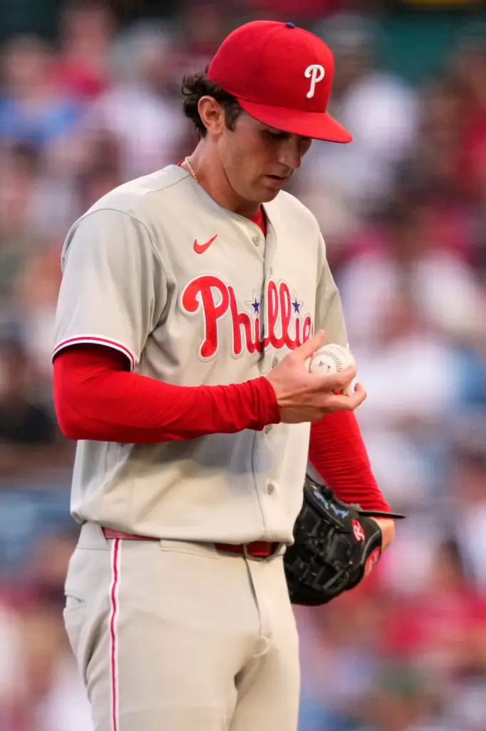 Philadelphia Phillies starting pitcher Andrew Painter stands on the mound...