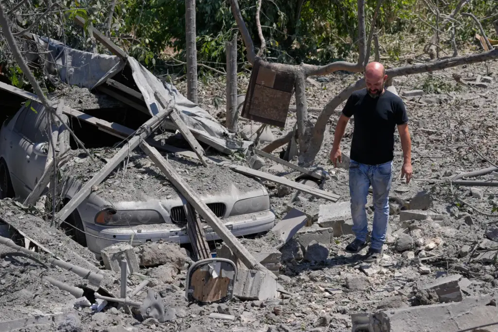 A man checks the site of a destroyed house that was hit in an Israeli airstrike.