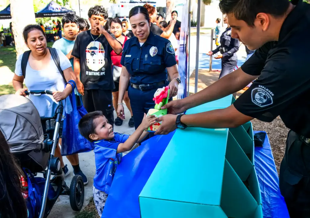 Santa Ana Explorer Luis Serafin hands out free goodies to...